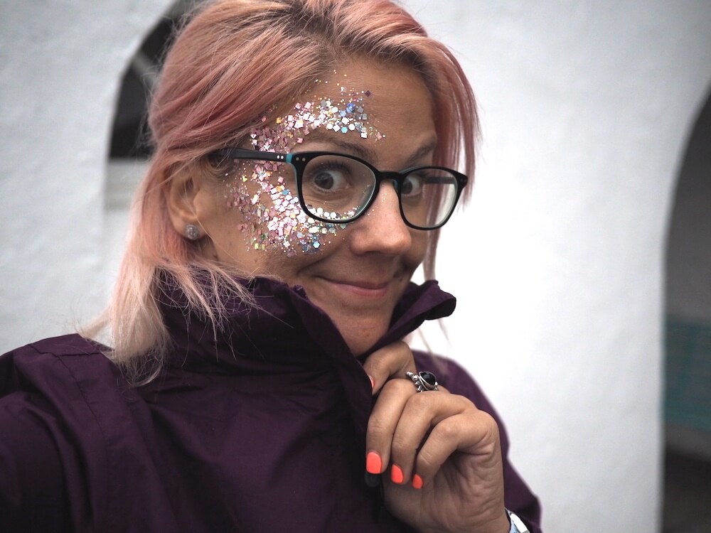 me with pink hair and glasses with glitter on her face
