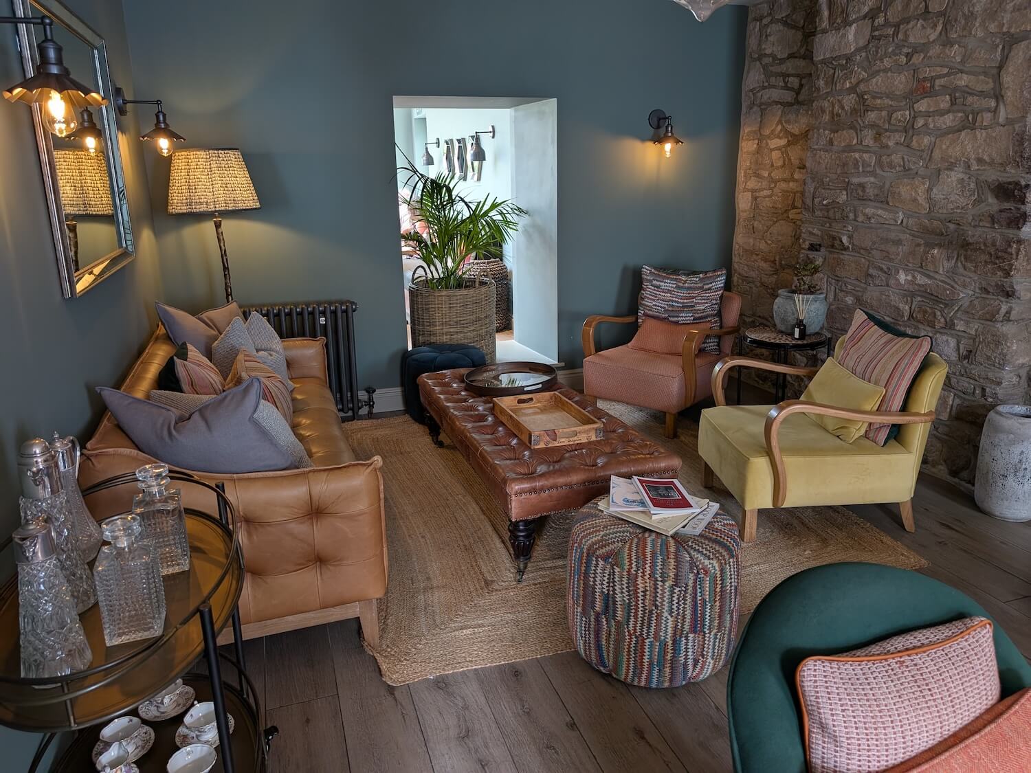 a living room with a stone wall and a couch