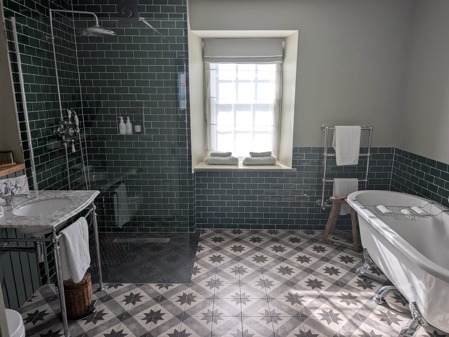 a bathroom with a tub and a shower in the blonde hedgehog hotel review